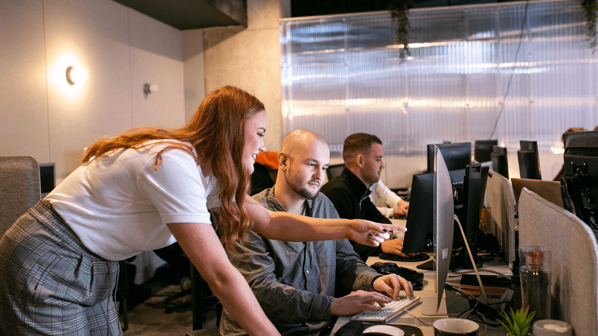 Workers discussing project on screen